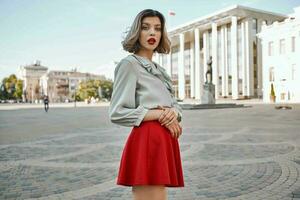 blonde in red skirt outdoors walking outdoors posing photo