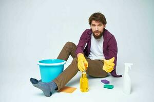 Man with detergent in the hands of a car wash providing housework hygiene services photo