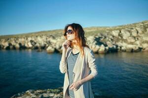 woman in sunglasses outdoors summer landscape sea fresh air photo