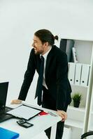 man in a suit in the office with documents technologies photo