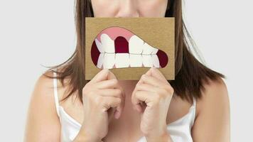 Asian woman in the blue shirt holding a brown paper with the broken tooth cartoon video