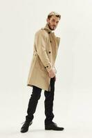 handsome man in coat fashion glamor studio full length photo