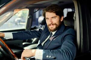 bearded man Driving a car trip luxury lifestyle success service rich photo