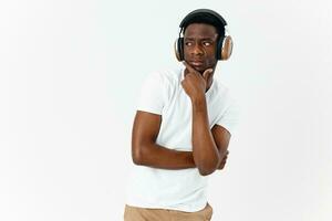 a man of african appearance with headphones listening to music photo