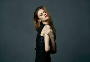 red-haired lady in a black dress gesturing with her hands hugs emotions makeup model photo