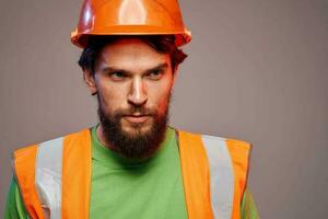 Man in orange paint construction security professional gray background photo