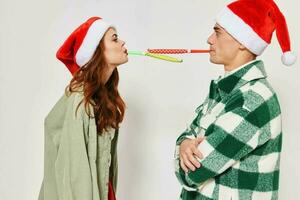 cute young couple in christmas hats multicolored pipes fun together holiday photo