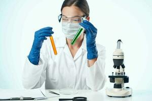 female laboratory assistant wearing yellow glasses chemical solution microscope research biotechnology photo