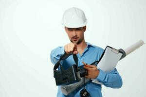 man in a construction helmet blueprints documents work engineer photo