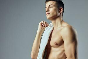 portrait of a sporty man pumped up body towel close-up photo