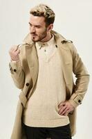 man gesturing with hand beige coat modern style cropped view photo