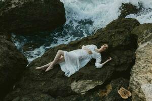 woman in white wedding dress on sea shore wet hair view from above photo