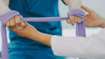 Physiotherapist working with patient in clinic, closeup video