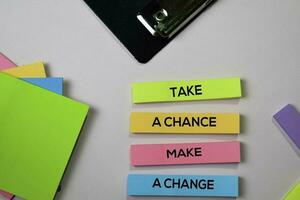 Take a Chance Make a Change text on sticky notes with office desk concept photo