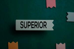 Superior write on a sticky note isolated on Office Desk photo