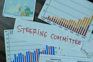 Concept of Steering Committee write on sticky notes isolated on Wooden Table. photo