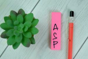 Concept of ASP Sign write on sticky notes isolated on Wooden Table. photo