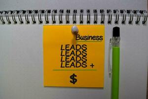 Leads plus Leads equal Money write on sticky note isolated on Office Desk photo