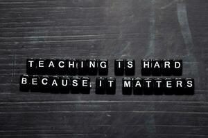 Teaching is hard because it matters on wooden blocks. Education, Motivation and inspiration concept photo
