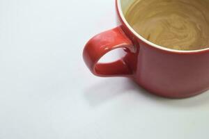 Close up hot cappuccino coffee in a red cup isolated on a white background photo