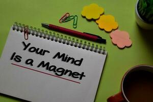 Your Mind Is a Magnet write on a book isolated on office desk. photo