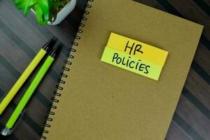 The Book of HR Policies isolated on Wooden Table. photo