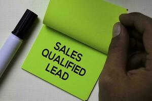 Sales Qualified Lead - SQL text on sticky notes isolated on office desk photo