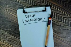 Concept of Self Leadership write on paperwork isolated on Wooden Table. photo