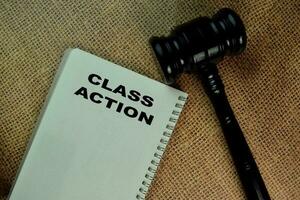 The Book of Class Action on office desk. and gavel photo
