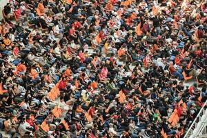 Crowds on Group of fans on the stadium Jakarta International Stadium. Jakarta, Indonesia, August 1, 2022 photo