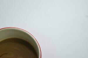 Close up hot cappuccino coffee in a red cup isolated on a white background photo