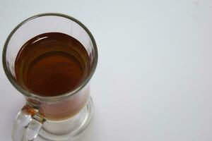 Black tea in a glass cup isolated on a white background photo