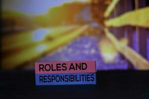 Roles and Responsibilities on the sticky notes with bokeh background photo