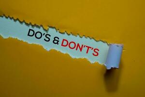 Do's and Don't's Text written in torn paper photo