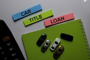 Car Title Loan write on sticky note and Toy Car. white background photo