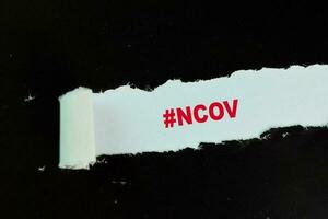 NCOV Text written in torn paper photo