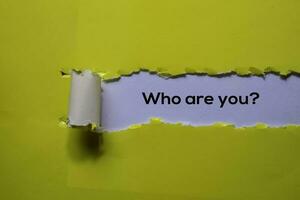 Close up Who Are You written in yellow torn paper photo