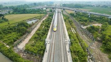 Aerial view of the High speed orange train on the railway station. High Speed Train Jakarta-Bandung. Bandung, Indonesia, November 22, 2022 photo