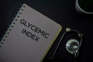 Glycemic Index write on a book isolated on Office Desk. Healthcare or Medical Concept photo