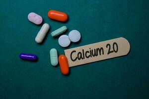 Calcium 20 write on sticky note isolated on Office Desk. Medical concept photo