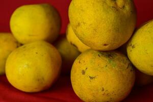 Fresh orange fruit in the red background photo