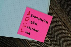 ADSL - Asymmetrical Digital Subscriber Line write on sticky notes isolated on Wooden Table. photo