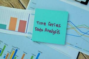 Concept of Time Series Data Analysis write on sticky notes isolated on Wooden Table. photo