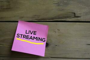 Live Streaming text on sticky notes with wooden background photo