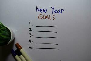 New Year Goals with check list write on white board background photo