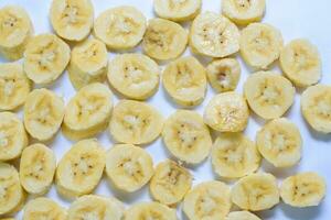 Close up slice yellow banana isolated on white background photo