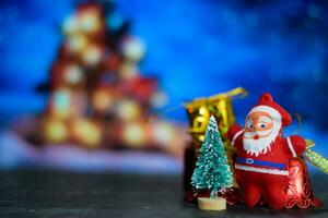 Close up decoration santa claus dolls and christmas gifts isolated on bokeh background photo