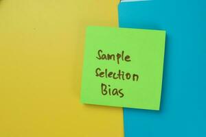 Concept of Sample Selection Bias write on sticky notes isolated on Wooden Table. photo