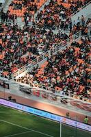 Crowds on Group of fans on the stadium Jakarta International Stadium. Jakarta, Indonesia, August 1, 2022 photo