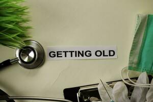 Getting Old with inspiration and healthcare medical concept on desk background photo